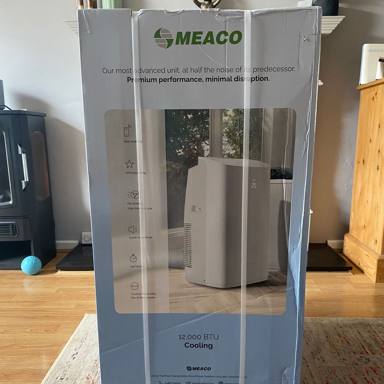 Packaging of the Meaco Cirro portable air conditioner in a living room