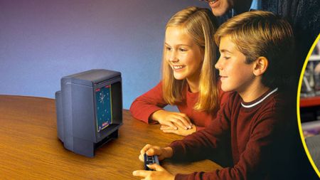 Two children sitting at table playing Vectrex Mini.
