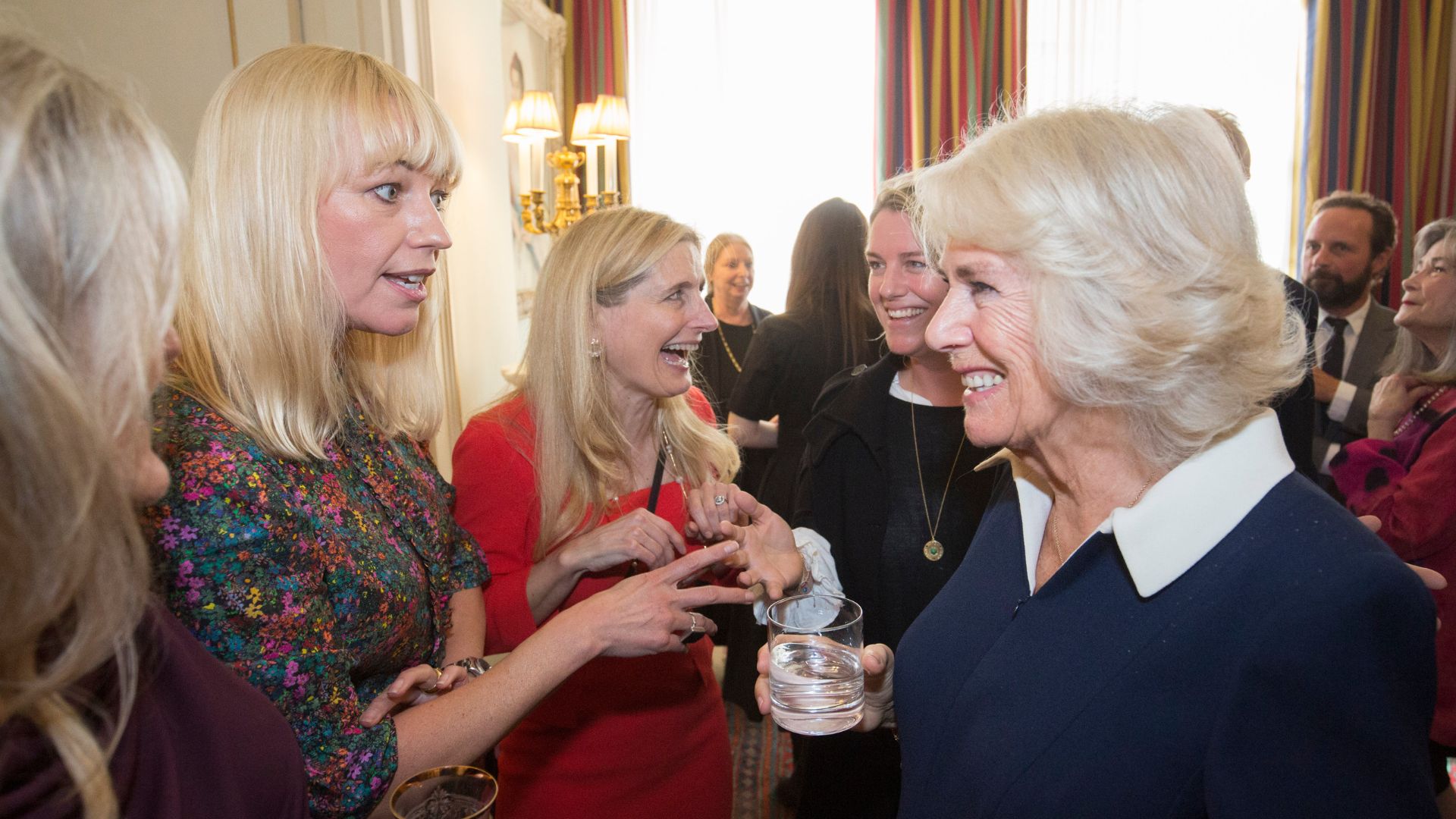 Queen Camilla speaks with BBC Radio 2 DJ Sara Cox at a reception hosted for the Queen's Reading Room in October 26, 2021