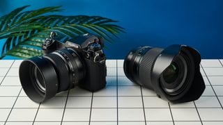 The Fujifilm GFX100S II on a white surface with a blue wall in the background