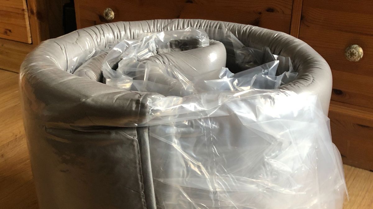 A MAXYOYO Japanese floor mattress rolledup in plastic after being unboxed