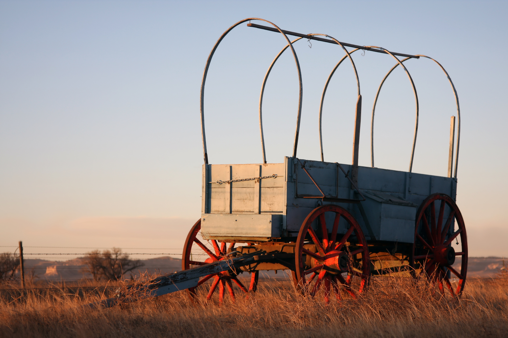 Pioneer wagon on the Oregon Trail at sunrise.