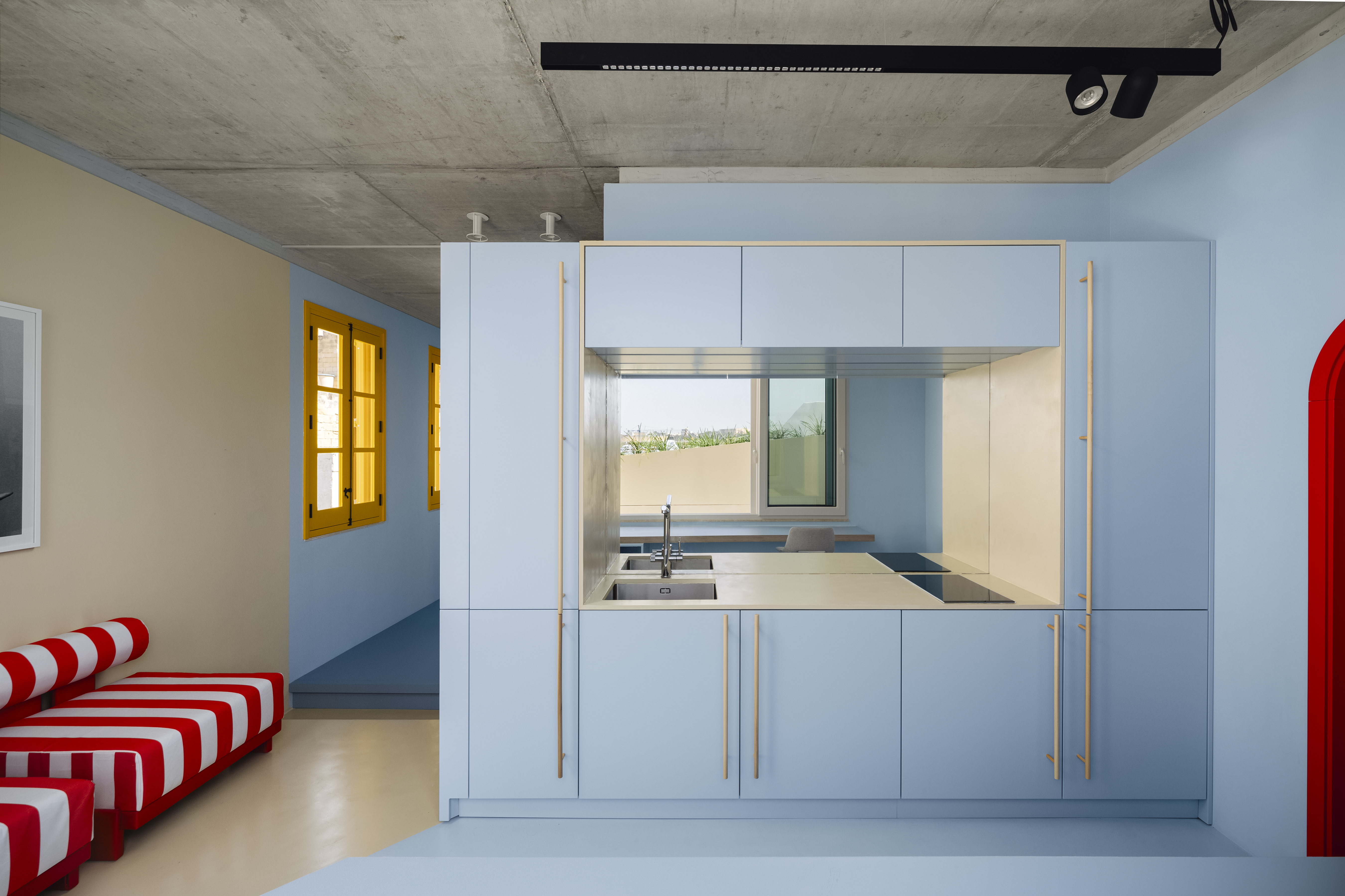 A kitchen painted blue - right from the cupboards to the floor