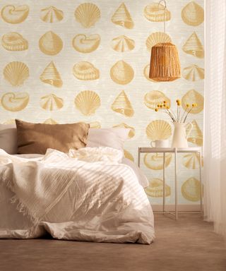 Yellow seashell printed wallpaper design in bedroom by Elizabeth Ockford