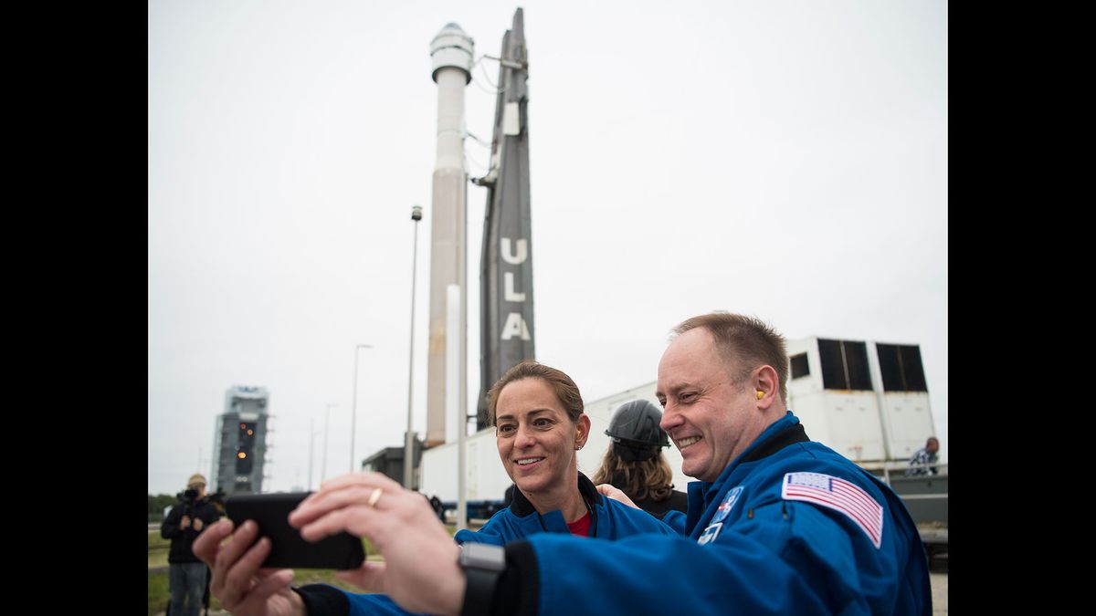NASA astronauts Nicole Mann, left, and Michael Fincke take a selfie as a United Launch Alliance Atlas V rocket with Boeing&rsquo;s CST-100 Starliner spacecraft onboard is seen as it is rollout out of the Vertical Integration Facility to the launch pad at Space Launch Complex 41 ahead of the Orbital Flight Test mission, Wednesday, Dec. 18, 2019 at Cape Canaveral Air Force Station in Florida.