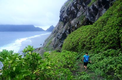 A hiker nears the shore on Ofu's neighbor isle, Olosega.