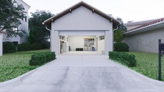 a garage with the door open and a wide, long driveway to support an article on how to declutter a garage for maximum efficiency
