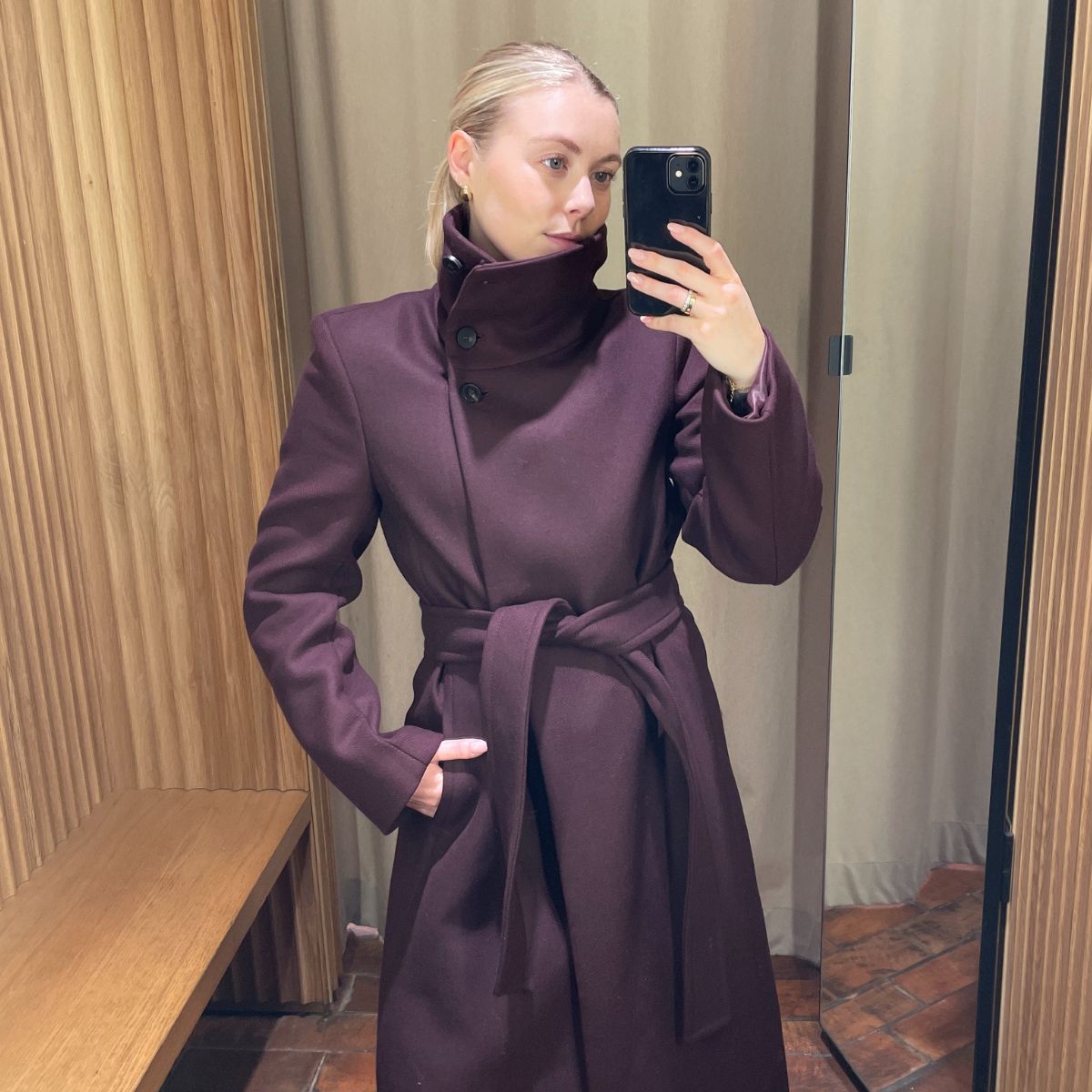Woman wears burgundy coat