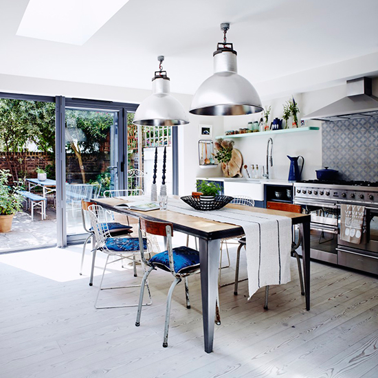 dining area with bespoke table mismatched dining chairs stainless steel range cooker