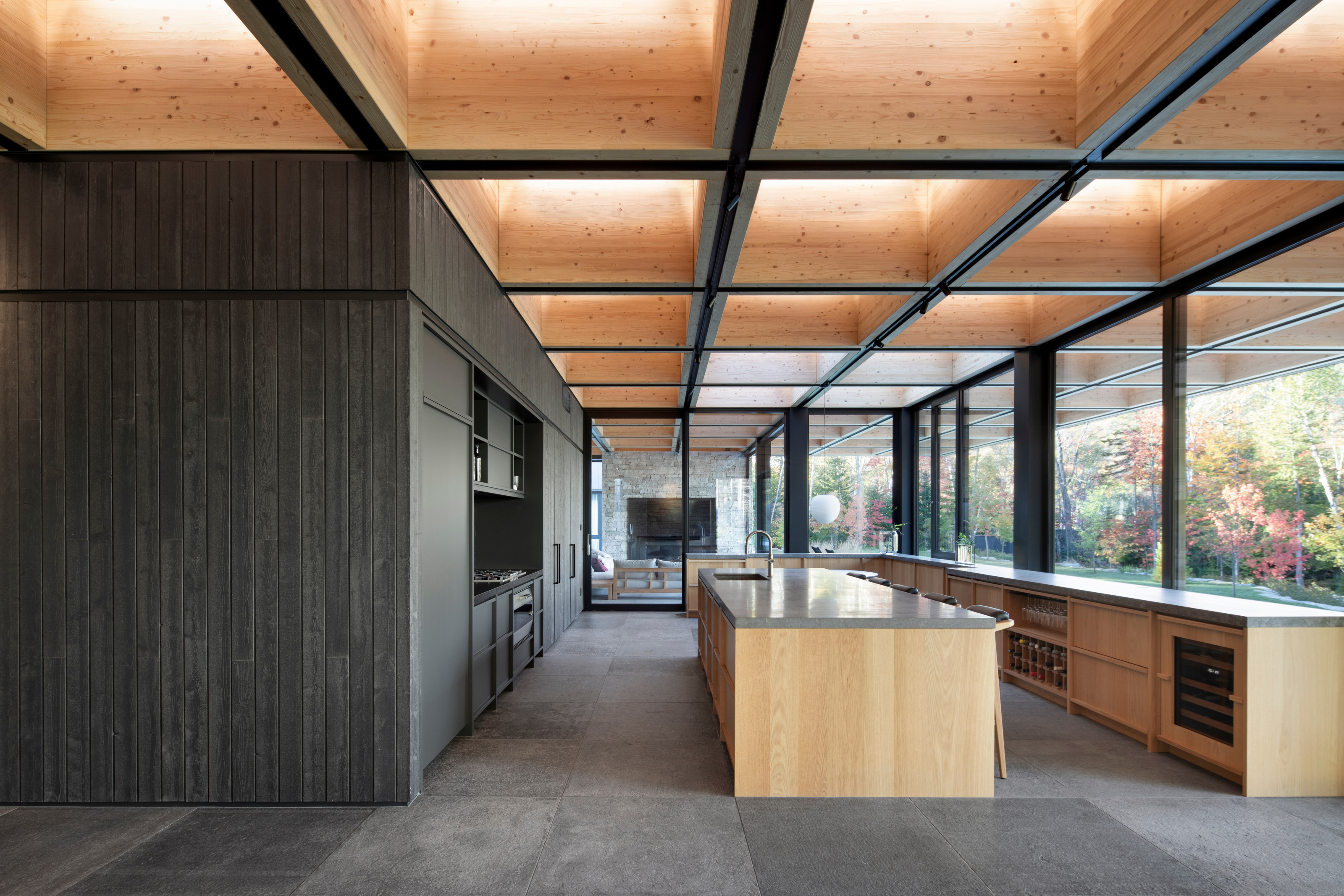 The dark timber cladding conceals a secondary kitchen and utility areas
