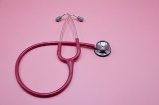 breast cancer - pink stethoscope on pink background
