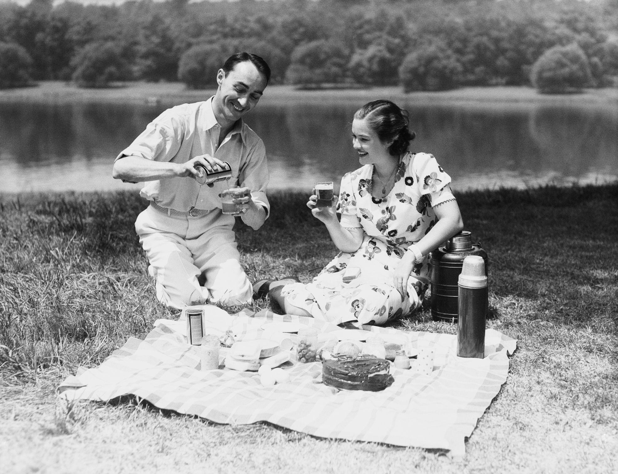 Couple enjoying summer picnic in the 1930s.