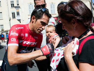 Alberto Contador mingles with fans before the start of stage 2