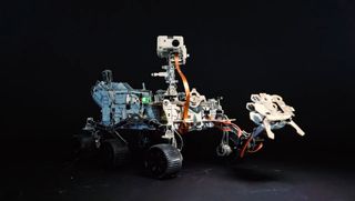 a four-wheeled robot with a robotic arm