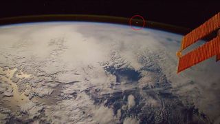 A screenshot from Paolo Nespoli's video of a meteoroid shows a fireball zipping through the atmosphere on Nov. 5, 2017. A red circle indicates the location of the fireball.