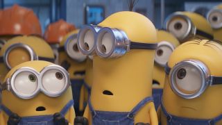 The lead Minions stand in front of a crowd in Minions: The Rise of Gru.