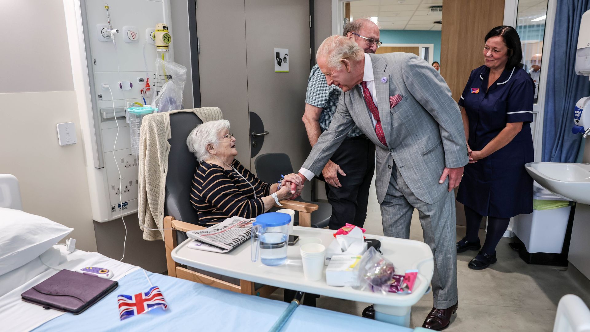 King Charles III talks with patient Jacqueline Page as she visits a ward during a visit where he officially opened Midland Metropolitan University Hospital