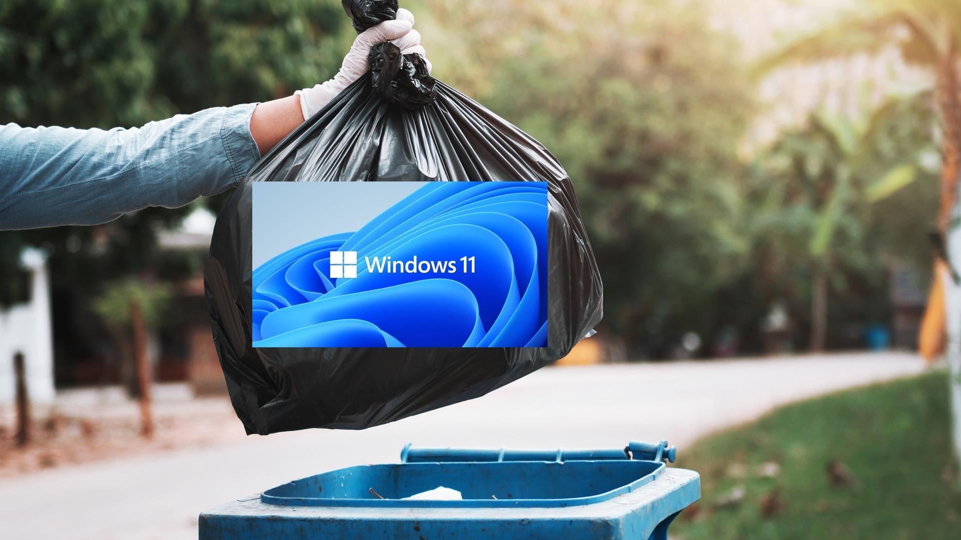 Alguien poniendo un poco de basura con la marca Windows 11 en un contenedor.