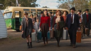 The Roberts family getting off a bus in Ten Pound Poms