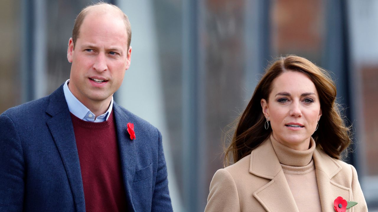 Prince William, wearing a red sweater and blue suit jacket, and Kate Middleton, wearing a camel coat and matching turtleneck sweater, visit Scarborough on November 3, 2022