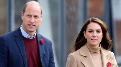 Prince William, wearing a red sweater and blue suit jacket, and Kate Middleton, wearing a camel coat and matching turtleneck sweater, visit Scarborough on November 3, 2022