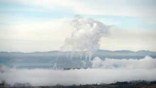 A wide shot of mist surrounding a coal-fired power station.