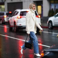 Woman in jeans crossing road