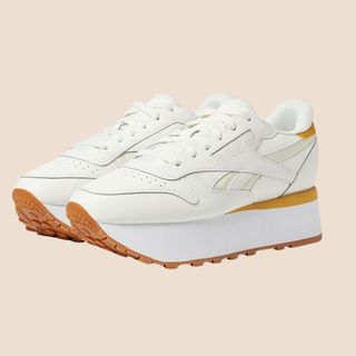 Flat lay image of triple layer white trainers