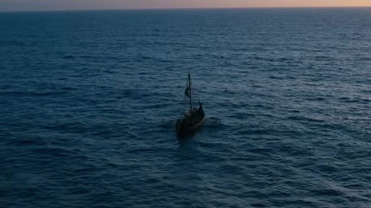 A ship looking very small on the vast ocean in The Odyssey