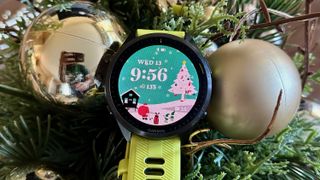 The Garmin Forerunner 965 with a festive watch face showing Santa golfing with his elves