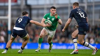 Calvin Nash of Ireland in action against Ben White, left, and Stafford McDowall of Scotland during Scotland vs Ireland at the Six Nations 2024 