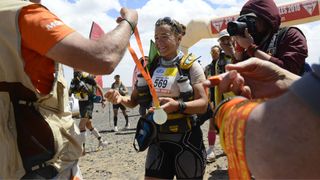 Sabrina Pace Humphreys at the finish line of the Marathon des Sables, collecting her medal