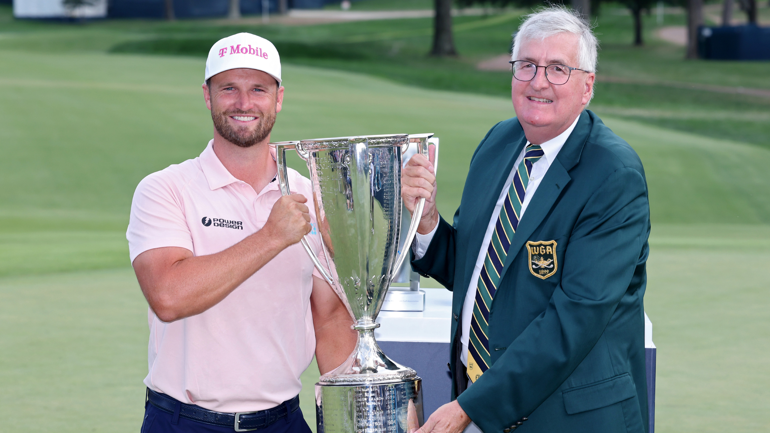 Wyndham Clark is presented with the BMW Championship trophy                             
