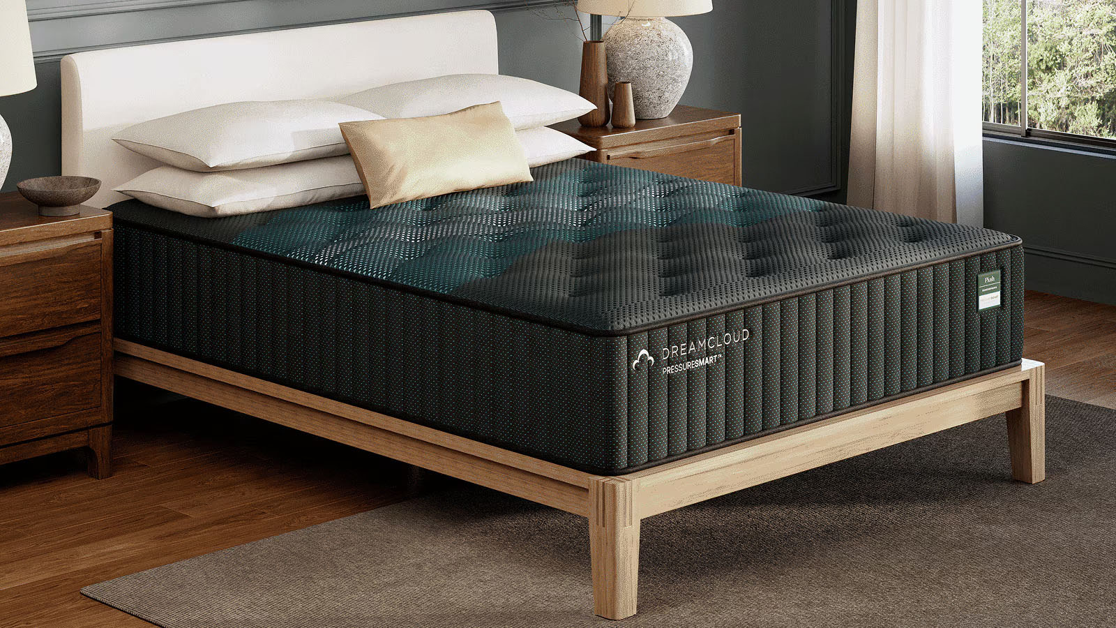 The DreamCloud PressureSmart Plush Mattress on a bed frame in a bedroom