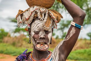 A woman from the African tribe Mursi with a big lip plate.