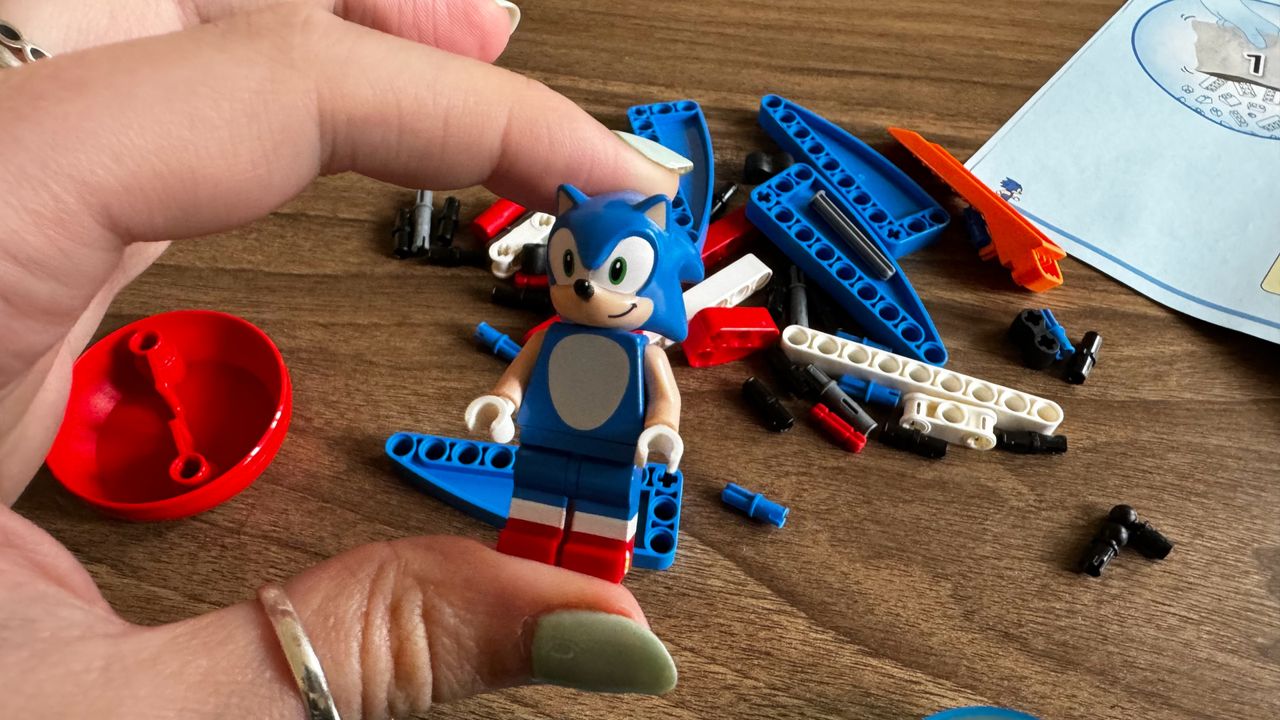 Lego Sonic vs. Dr. Eggman's Death Egg Robot set under construction on a wooden table