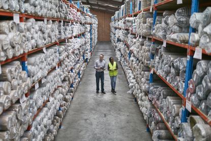Workers in a carpet warehouse similar to those operated by Likewise Group
