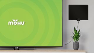 The Mohu Leaf in a living room near a TV.