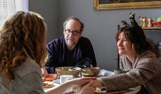 Private Life Paul Giamatti Kathryn Hahn talking at the table with a guest