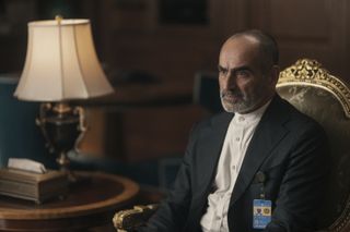 Abbas sitting in the chair in The Night Agent season 2