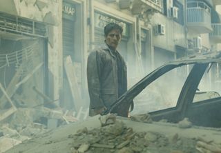 Sergio (Joaquín Furriel) stands amid rubble in Rest in Peace (2024)