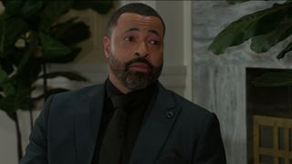 Timon Kyle Durrett as Bill in all black in Beyond the Gates