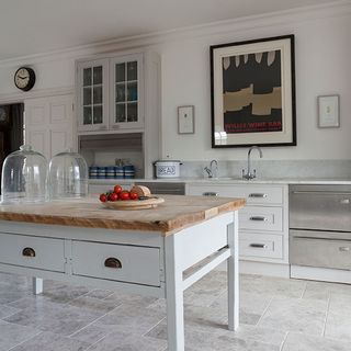 kitchen room with marble worktop and white wall with wooden table