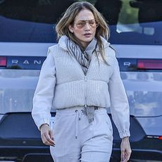 Jennifer Lopez walks to her car wearing a puffer vest and sweatpants