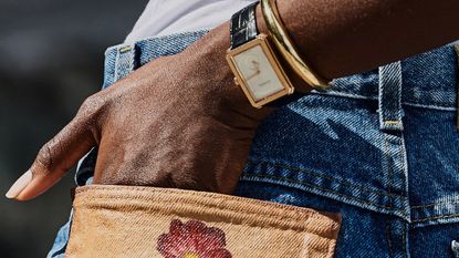 Woman putting her hand into her denim pocket