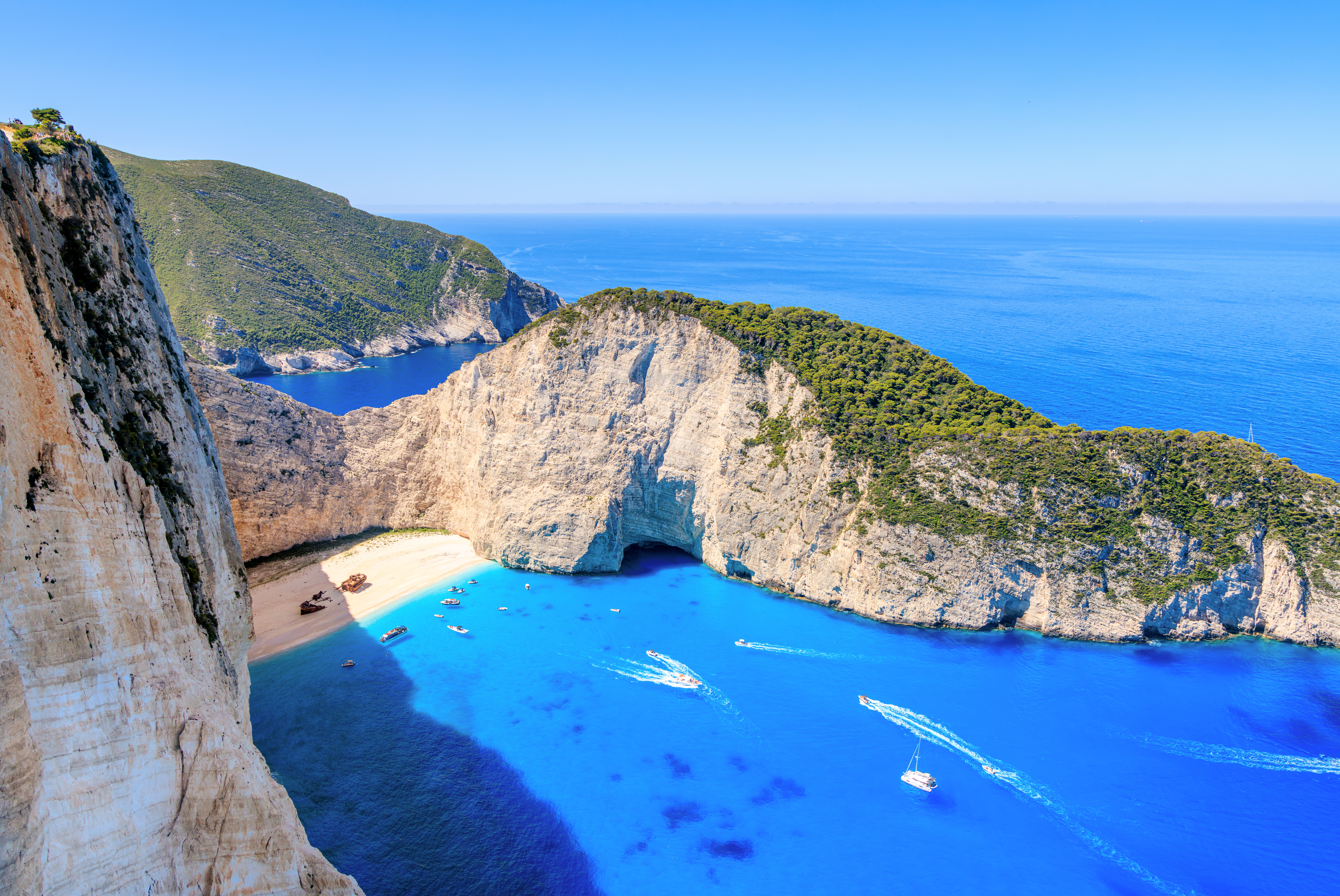 Boats approach the beach at Navagio Bay on June 3, 2025 in Volimes, on the island of Zakynthos, Greece