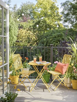 Colourful bistro set on small decked balcony