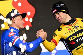 Dutch Mathieu van der Poel of AlpecinDeceuninck and winner Belgian Wout van Aert of Team JumboVisma react on the podium after the E3 Saxo Bank Classic one day cycling race 2041km from and to Harelbeke on March 24 2023 Photo by JASPER JACOBS Belga AFP Belgium OUT Photo by JASPER JACOBSBelgaAFP via Getty Images
