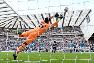 Kieran Trippier of Newcastle United scores their side's third goal from a free kick as Ederson of Manchester City attempts to make a save during the Premier League match between Newcastle United and Manchester City at St. James Park on August 21, 2022 in Newcastle upon Tyne, England.