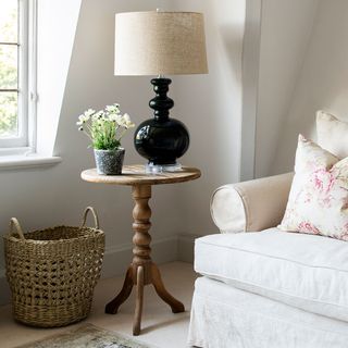 wooden round side table with white flower vase